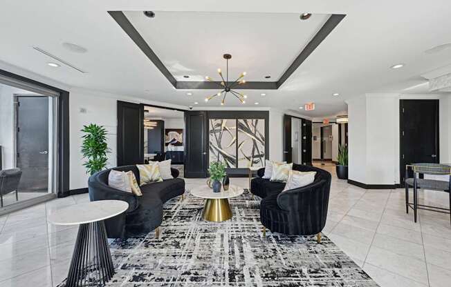 Resident lounge with two black couches at Dominion Post Oak apartments in Houston, TX