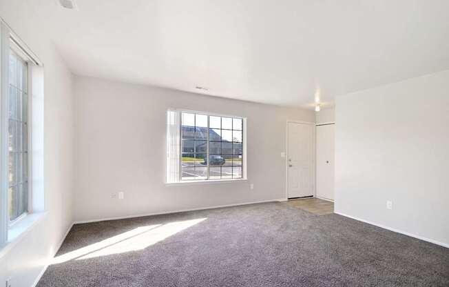 Spacious living room with natural light at Farmbrooke Manor Apartments in Clinton Township MI