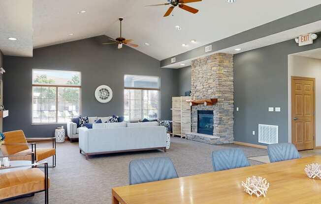 clubhouse living room with gray walls and a stone fireplace
