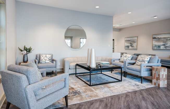 a living room with blue furniture and a mirror