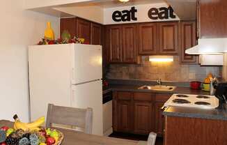 a kitchen with a bowl of fruit on the table