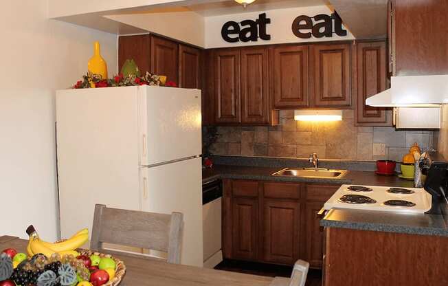 a kitchen with a bowl of fruit on the table