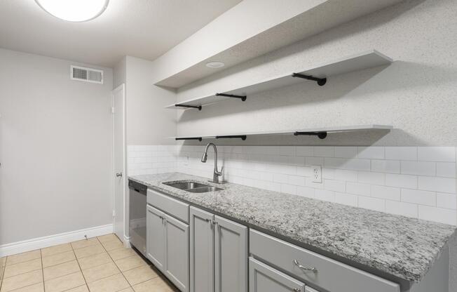 a kitchen with a sink and a mirror