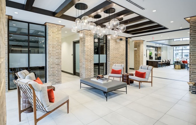 the lobby of a hotel with chairs and a coffee table