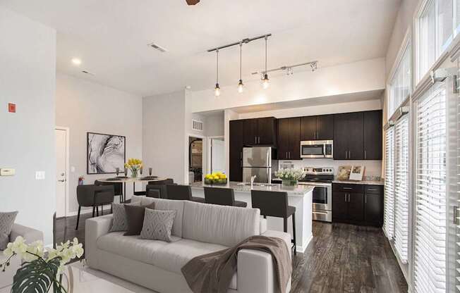A modern kitchen with dark wood cabinets and a white island.
