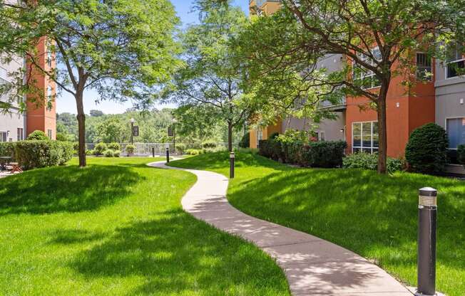 a path through the grass in front of a building