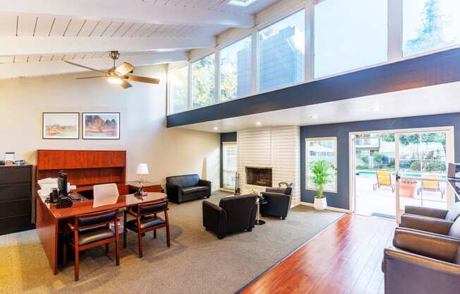 A living room with a fireplace and a ceiling fan.