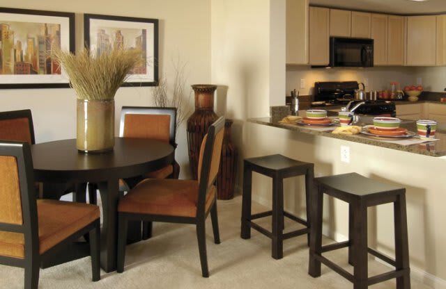 a kitchen and dining area with a table and chairs
