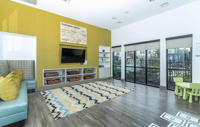 a living room filled with furniture and a large window