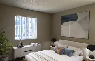 a bedroom with a bed and a dresser and a window