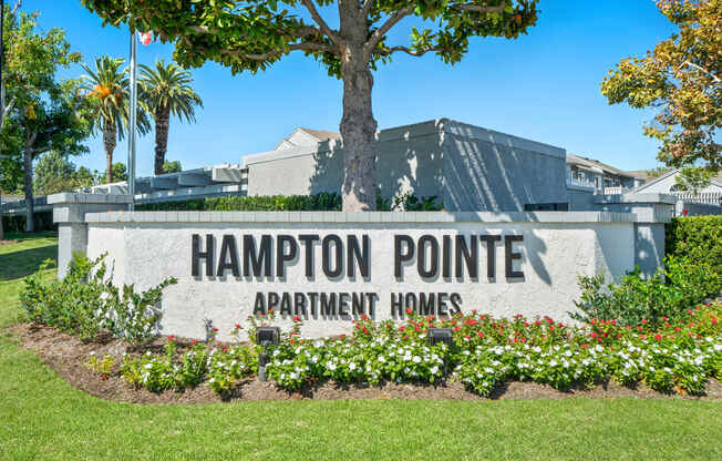 the sign for the hamppton point apartment homes entrance in front of a building