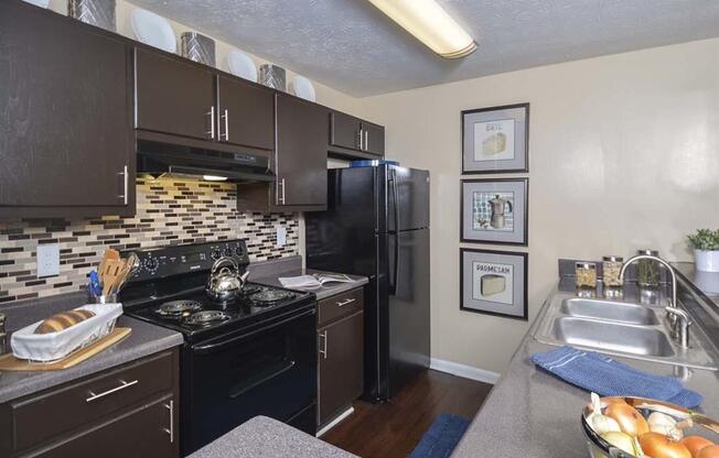 kitchen with tiled backsplashat Harvard Place Apartments, Lithonia, GA, 30058