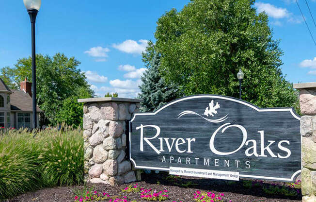 Welcome sign for River Oaks Apartments