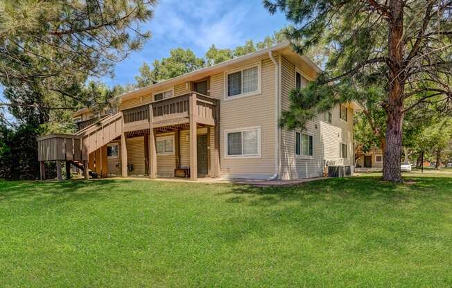A large two-story house with a balcony and a deck.