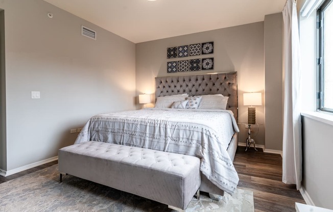 a bedroom with a bed and a window