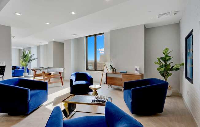 a living room with blue chairs and a table