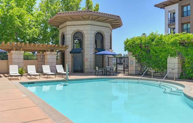 A pool with a small building next to it.