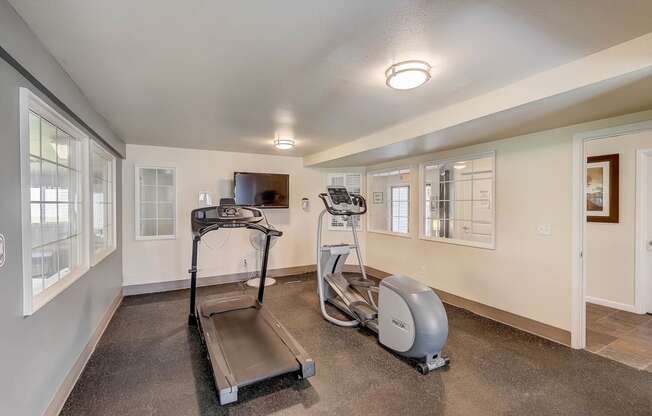 Gym at Glen at North Creek, Everett with a treadmill and a television