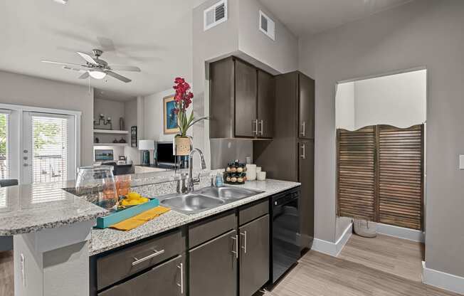 an open kitchen with stainless steel appliances and granite counter tops