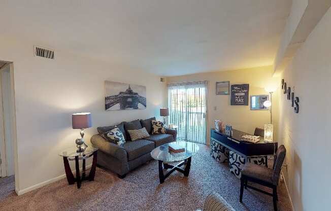 a living room with a couch table and chairs