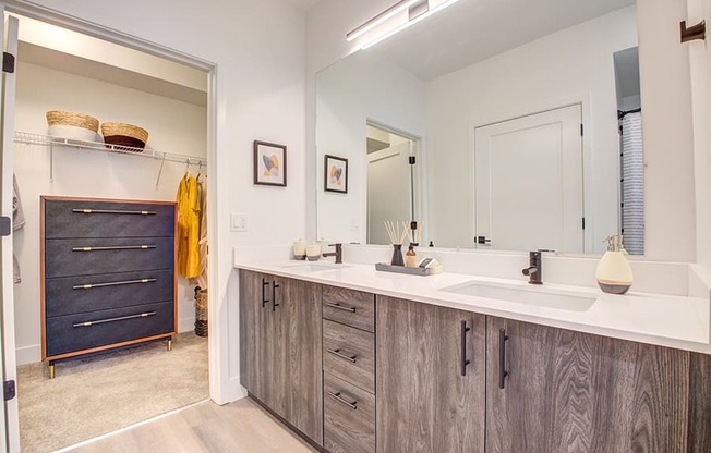 a bathroom with a large mirror and double sinks