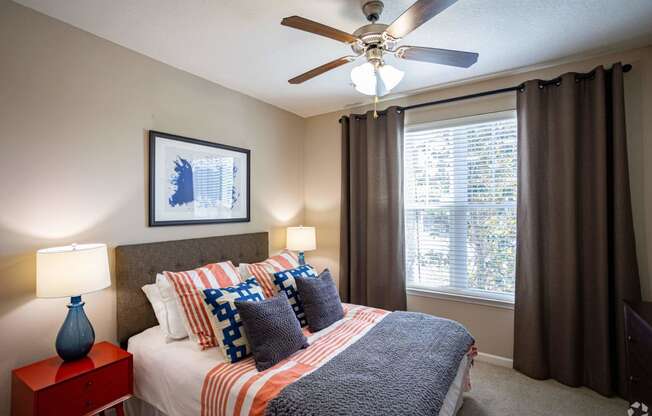 a bedroom with a bed and a ceiling fan