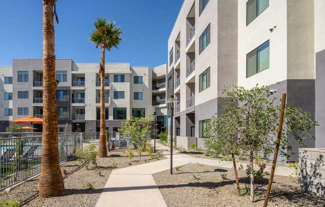 an apartment building with a courtyard and palm trees