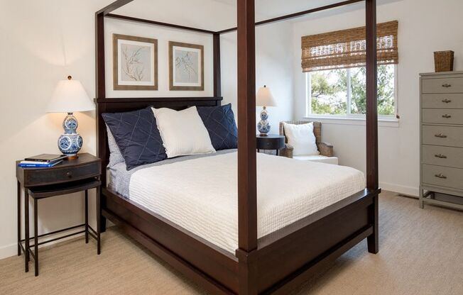 Phoenixville apartment bedroom with a canopy style bed, carpet, and large windows at Yardley Crossing