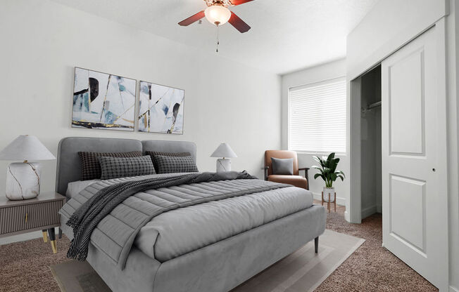 a bedroom with a bed and a ceiling fan