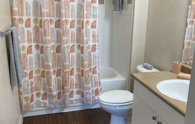 a bathroom with a toilet and a shower curtain