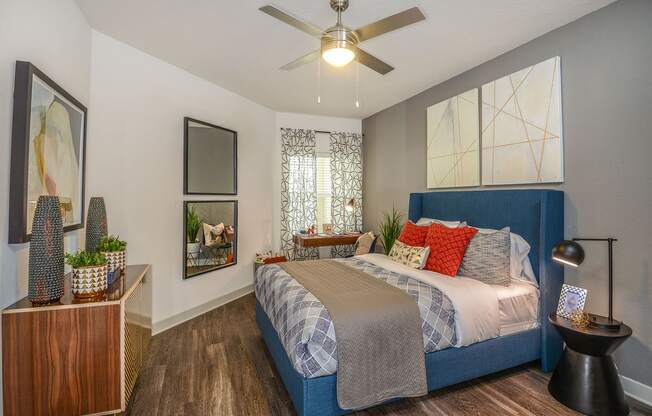 bedroom with ceiling fan and wood flooring at the district at highland village apartments