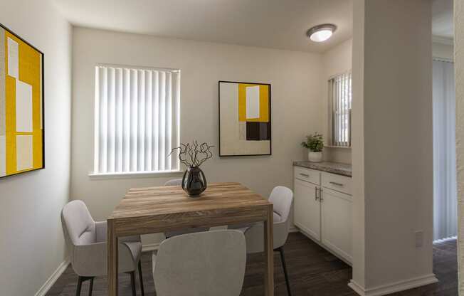 This is a photo of a virtually staged dining room room in the 970 square foot 2 bedroom, 2 bath apartment at Preston Park Apartments in Dallas, TX