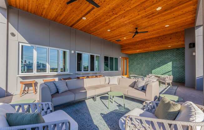 a living room filled with furniture and a wooden ceiling
