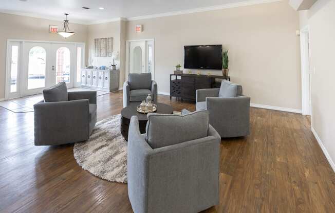 View of clubroom with seating, tv, and coffee bar.