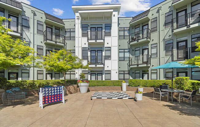A sunny day at a courtyard with a checkerboard pattern on the ground.