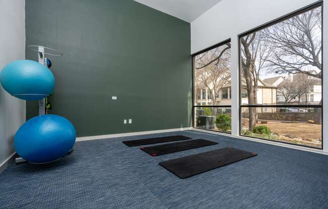 room with exercise equipment and large windows