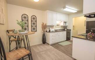 A kitchen with a table and chairs in it at Zinfandel Village Apartments, California, 95670