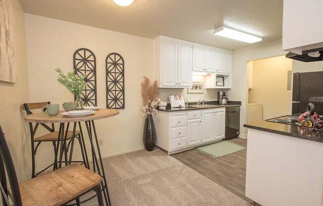 A kitchen with a table and chairs in it at Zinfandel Village Apartments, California, 95670