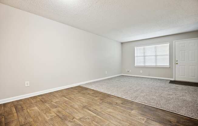 a bedroom with hardwood floors and grey walls