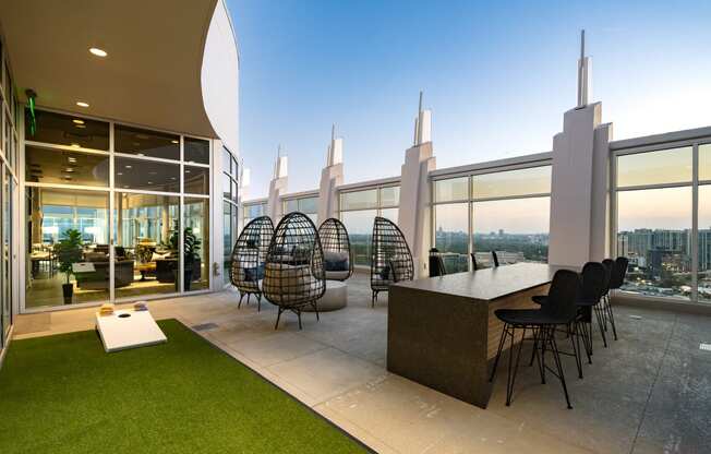 a room with a view of a city and a table and chairs in a building