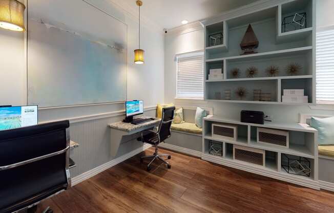 a home office with a blue wall and hardwood flooring