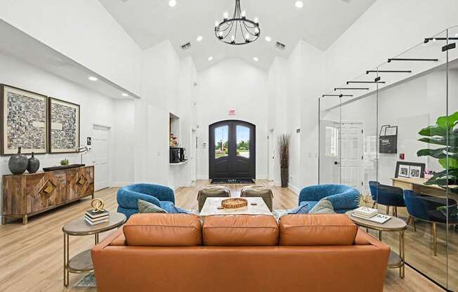 A living room with a brown sofa and a TV on the wall.