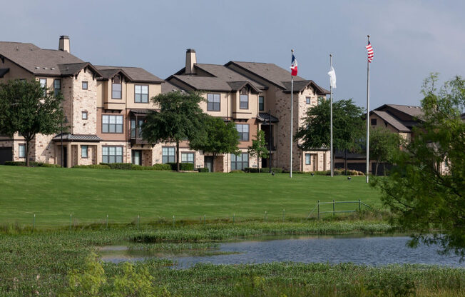A row of houses with a flag flying in front of them.