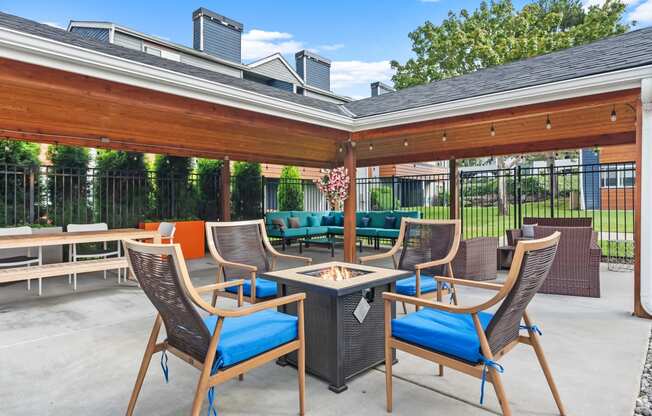 a patio with tables and chairs and a gazebo