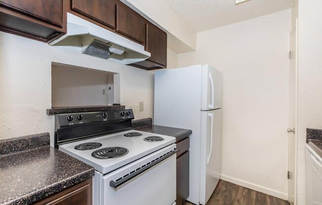 a stove top oven sitting inside of a kitchen