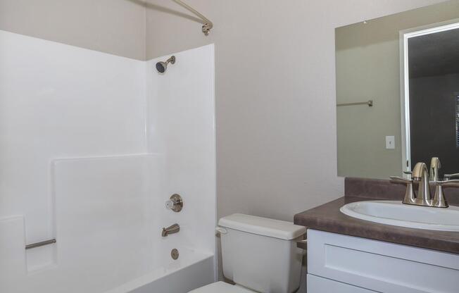 a large white tub sitting next to a sink