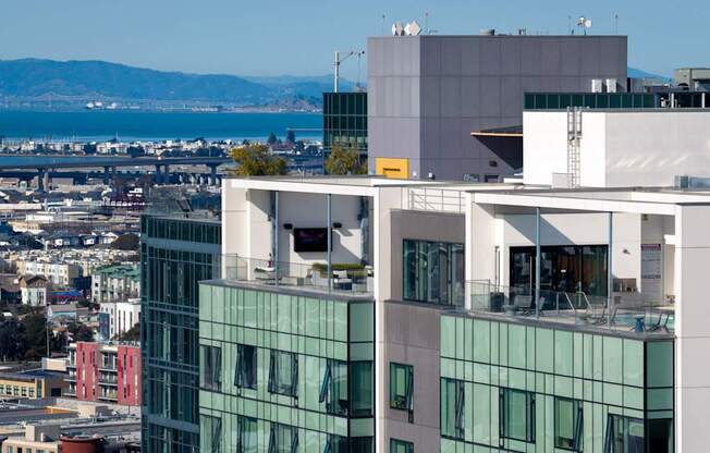 A modern building with glass windows is seen from a distance.