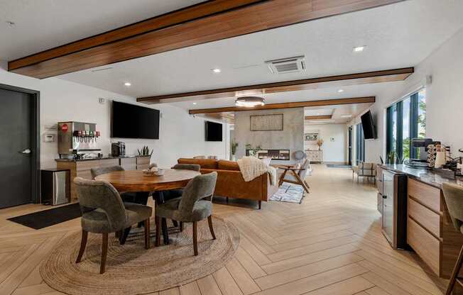 a living room and dining room with a table and chairs