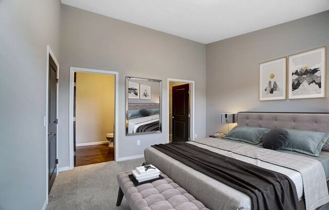 a bedroom with a large bed and a mirror