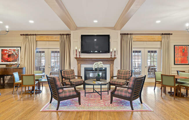 a living room with a fireplace and a table and chairs